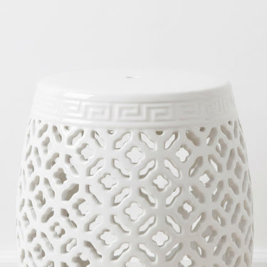Polished white finish and decorative open-weave design on a sculptural ceramic stool