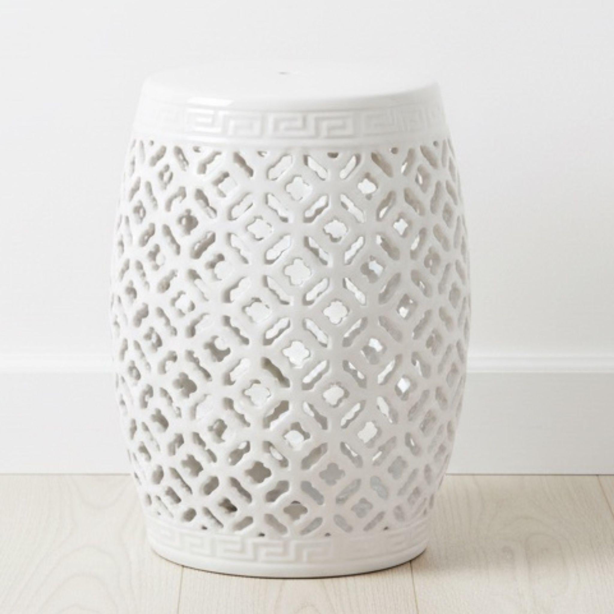 Minimalist white lattice ceramic stool styled as a bright decorative accent in a sunlit, airy room.