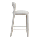 A off white textured fabric bar stool with a curved back and four legs connected by a black footrest.