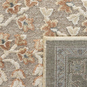 close-up of the traditional botanical floral pattern on the beige area rug
