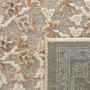 close-up of the traditional botanical floral pattern on the beige area rug