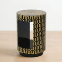 Modern round side table with a  geometric inlay pattern, featuring a glossy black center panel and a circular top.