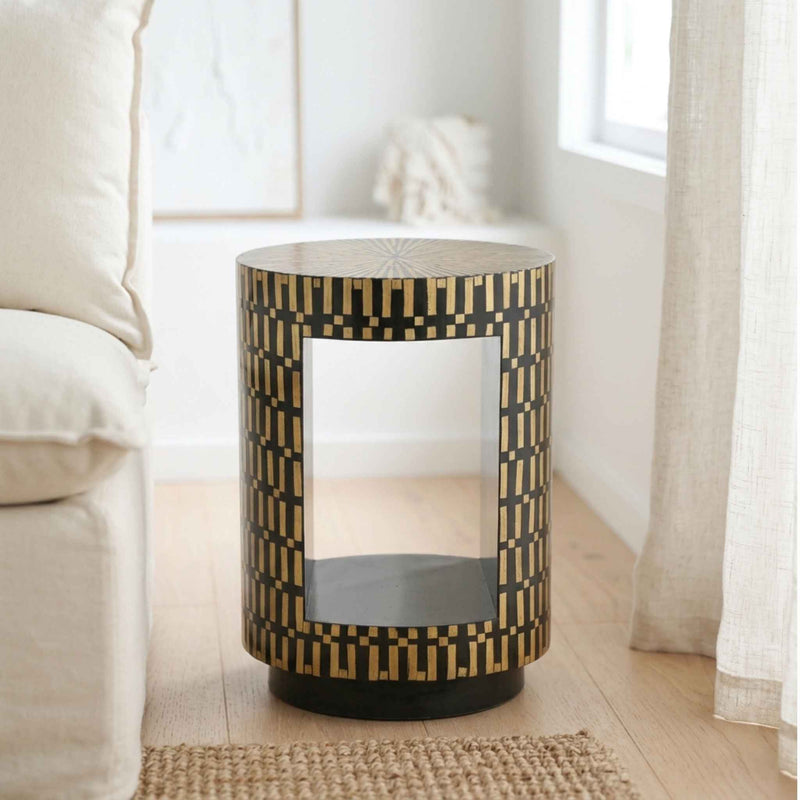 Living room side table with a black and bamboo geometric inlay pattern and a center opening panel, styled in a bright, modern living room next to a cream sofa.