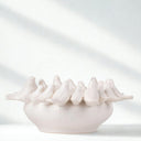 White Ceramic Birds Bowl on plain surface  showing bowl shape and birds