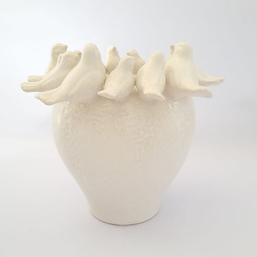 White Ceramic Birds Vase styled simply on a plain backdrop