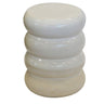 White ceramic stool with stacked ring design on a white background