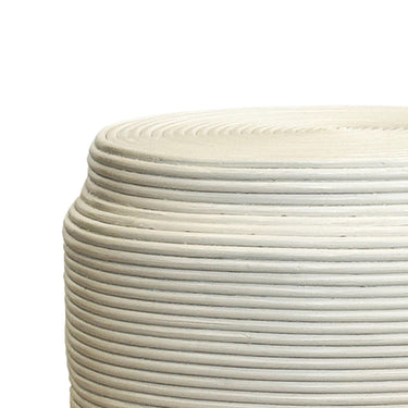 Close-up of spiral coiled rattan detail on white accent stool