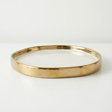 Irregular white and gold ceramic vanity tray.