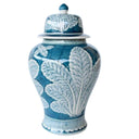 a blue and white vase with a leaf design on it