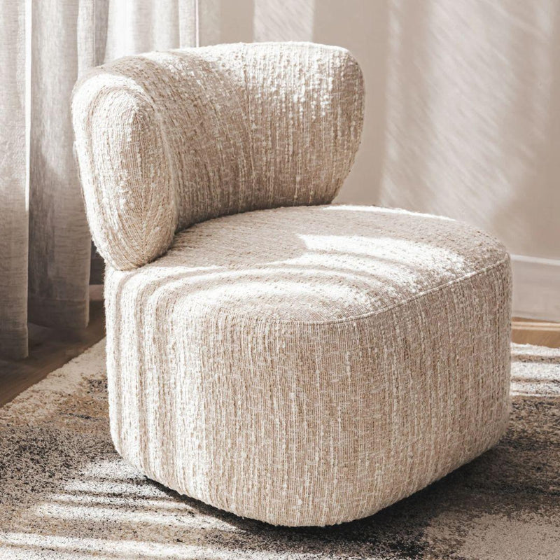 Thalia swivel occasional chair upholstered in a textured fabric styled in a cozy bedroom reading nook