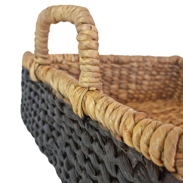 Close-up of handwoven water hyacinth texture and black-natural contrast on basket tray
