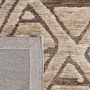 Close-up view of the Xanadu Earthstone rug fibres, highlighting the soft polyester pile texture and the rich colour contrast within the geometric linework.