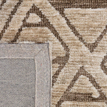 Close-up view of the Xanadu Earthstone rug fibres, highlighting the soft polyester pile texture and the rich colour contrast within the geometric linework.