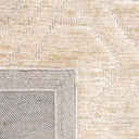 Close-up view of the Xanadu Parchment rug fibres, the soft polyester pile texture and the subtle colour variations within the geometric linework.