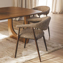 Set Yvette coco boucle style dining chairs around a modern dining room table.