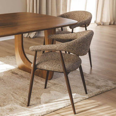 Set Yvette coco boucle style dining chairs around a modern dining room table.