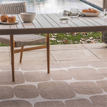 zira outdoor rug in desert styled ona Outdoor patio witha a table and chairs