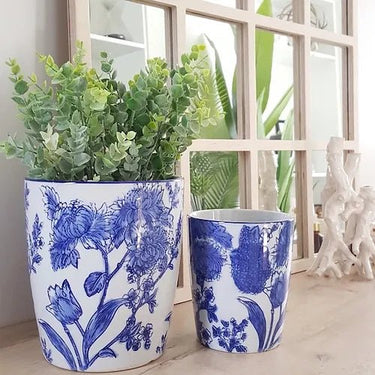 Blue floral ceramic planter pots with succulents on table