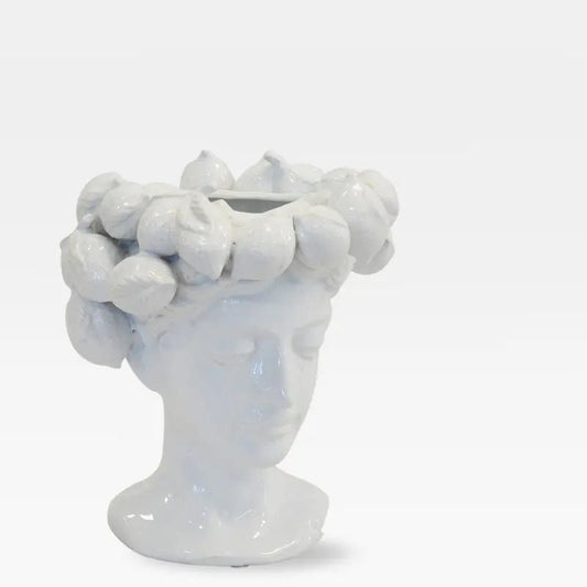 White ceramic face vase with a lemon crown